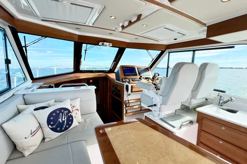 American Girl Yacht Photos Pics Luxurious 2021 Back Cove 390 yacht interior with helm, seating, and panoramic windows.