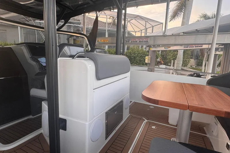  Yacht Photos Pics Interior of 2021 Nimbus T9 boat with seating and wooden table.