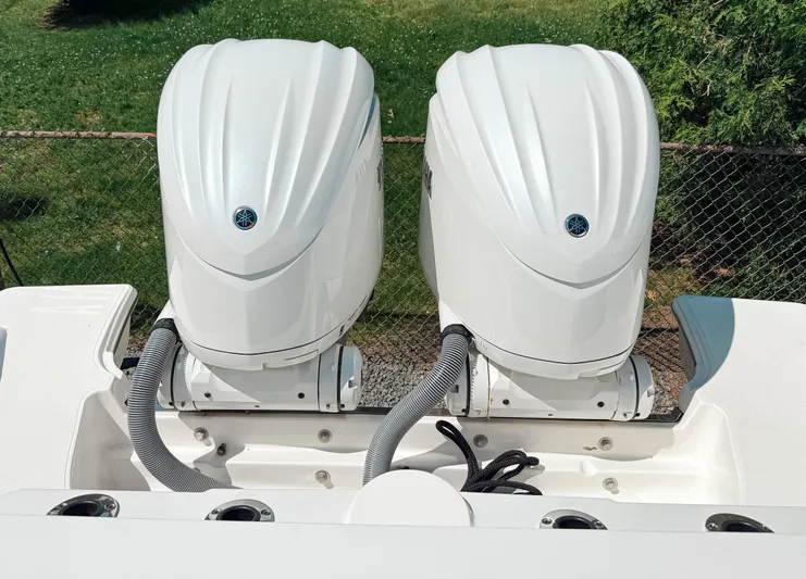  Yacht Photos Pics 2024 Pursuit S 288 Sport boat with dual outboard engines, viewed from the rear.