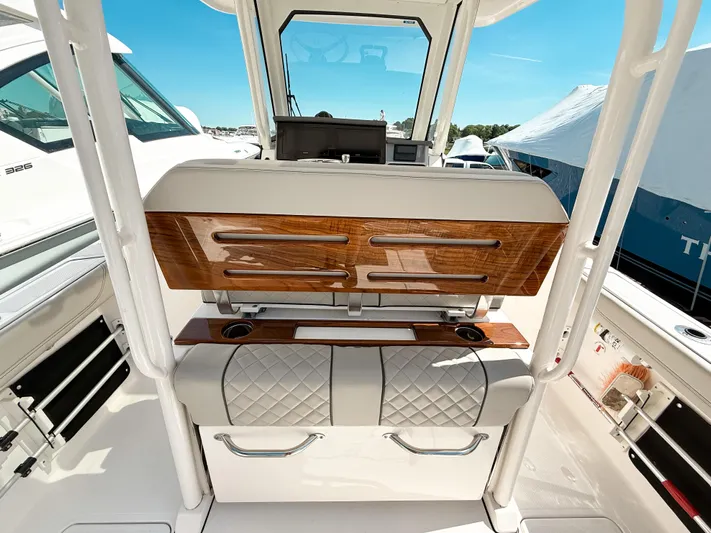  Yacht Photos Pics 2024 Pursuit S 288 Sport boat interior with luxurious seating and wood accents.