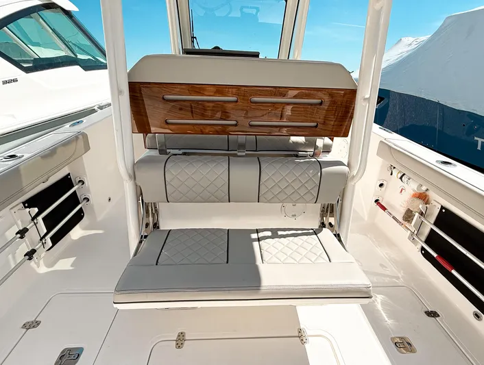  Yacht Photos Pics 2024 Pursuit S 288 Sport boat interior with cushioned seating and sleek design.