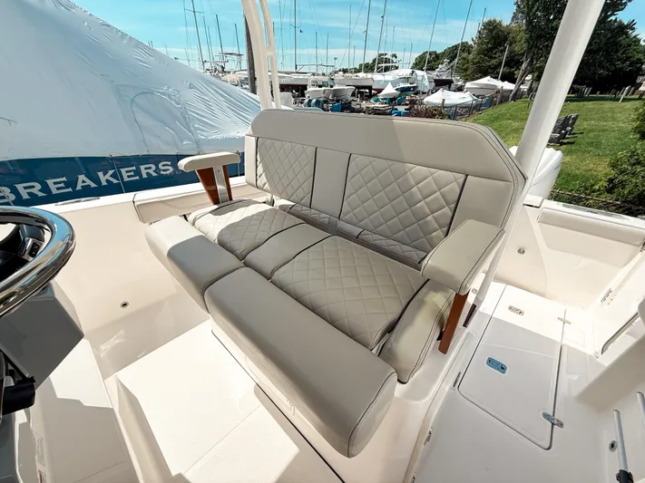  Yacht Photos Pics 2024 Pursuit S 288 Sport boat interior with cushioned seating and elegant design.