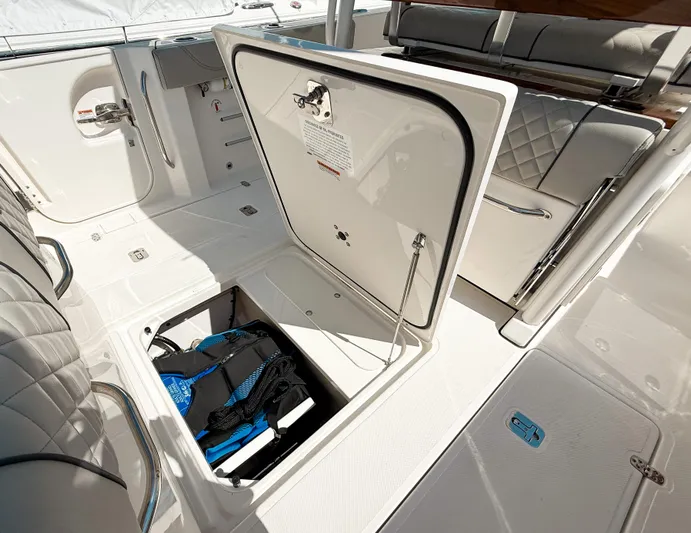  Yacht Photos Pics 2024 Pursuit S 288 Sport boat storage compartment with open hatch and visible equipment.