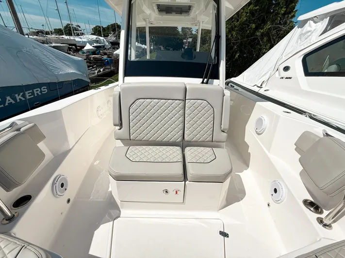 Yacht Photos Pics 2024 Pursuit S 288 Sport boat interior with cushioned seating and modern design.
