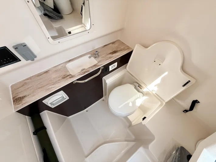  Yacht Photos Pics 2024 Pursuit S 288 Sport boat bathroom with sink and toilet.