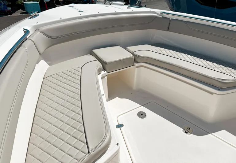  Yacht Photos Pics 2024 Pursuit S 288 Sport boat interior with cushioned seating and sleek design.