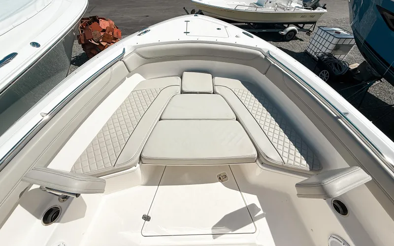  Yacht Photos Pics 2024 Pursuit S 288 Sport boat interior with cushioned seating and diamond-patterned upholstery.