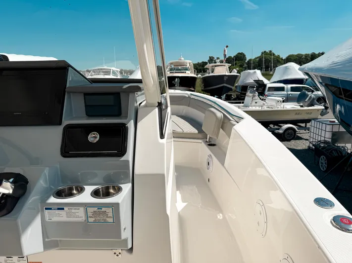  Yacht Photos Pics 2024 Pursuit S 288 Sport boat interior with control panel and seating area.