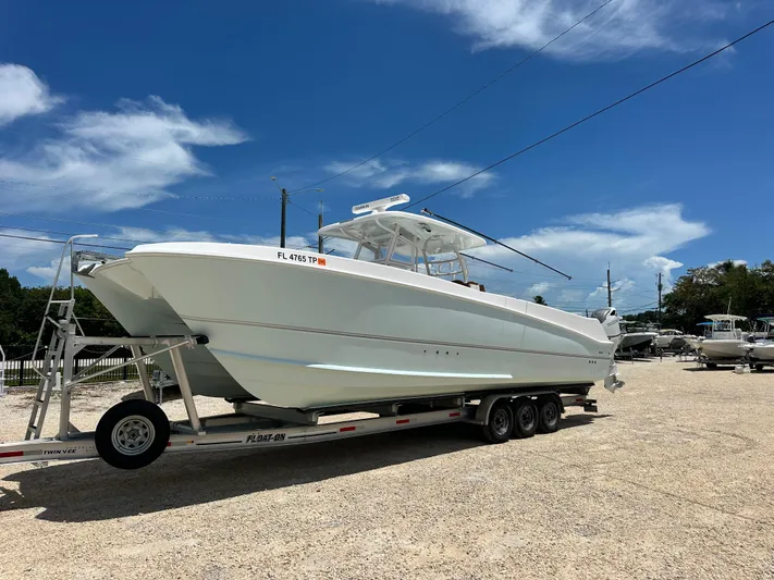  Yacht Photos Pics 2023 Twin Vee 340 GFX CC boat on trailer under clear blue sky.