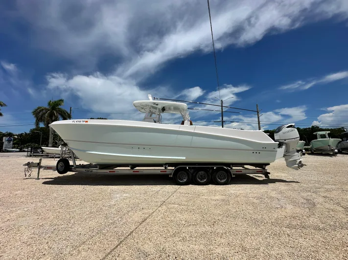  Yacht Photos Pics 2023 Twin Vee 340 GFX CC boat on trailer under clear blue sky.