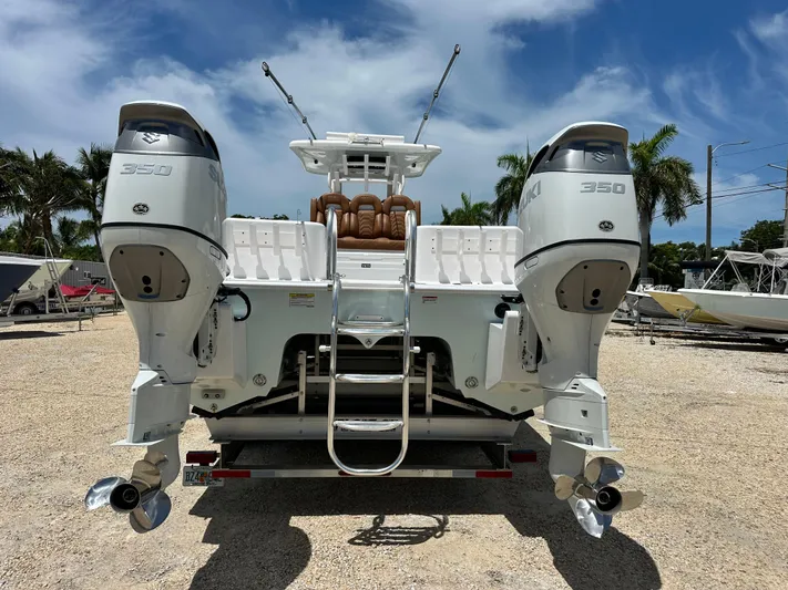  Yacht Photos Pics 2023 Twin Vee 340 GFX CC boat with dual Suzuki 350 engines, parked outdoors.