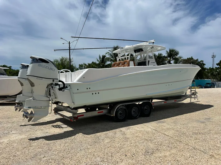  Yacht Photos Pics 2023 Twin Vee 340 GFX CC boat on trailer with dual Suzuki outboard motors.