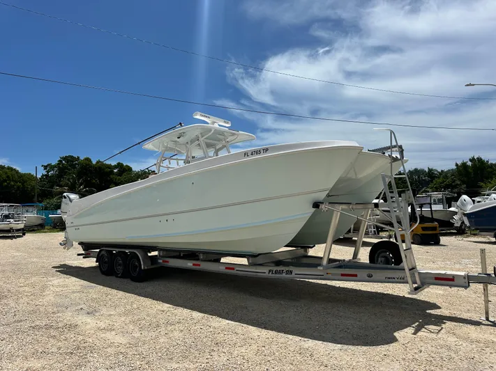  Yacht Photos Pics 2023 Twin Vee 340 GFX CC boat on trailer under clear blue sky.