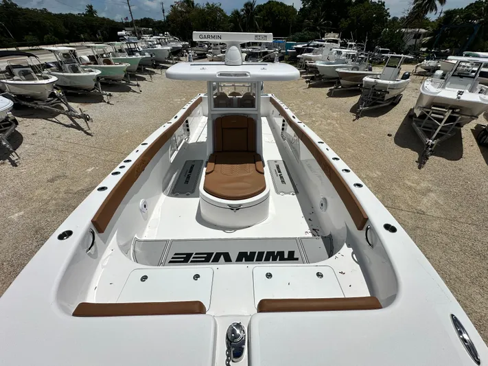  Yacht Photos Pics 2023 Twin Vee 340 GFX CC boat, white with brown accents, displayed among other boats.