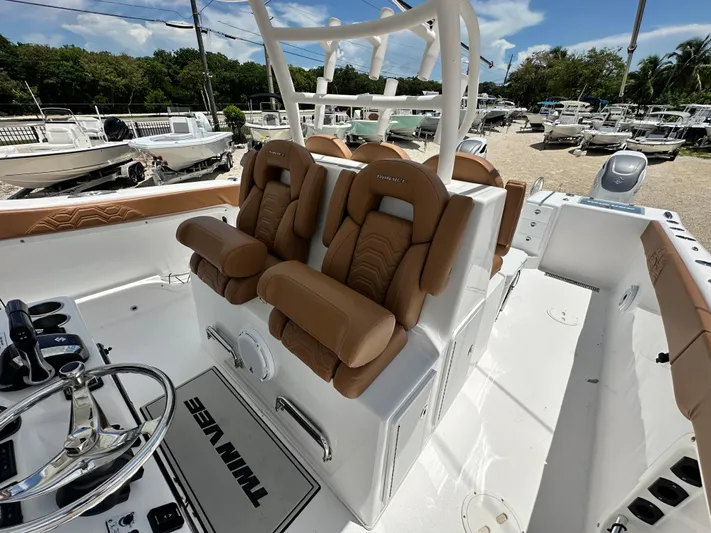  Yacht Photos Pics 2023 Twin Vee 340 GFX CC boat interior with tan seats and steering wheel.