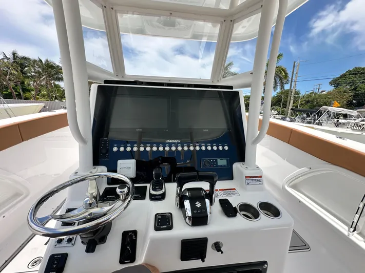  Yacht Photos Pics 2023 Twin Vee 340 GFX CC boat dashboard with steering wheel and control panel.