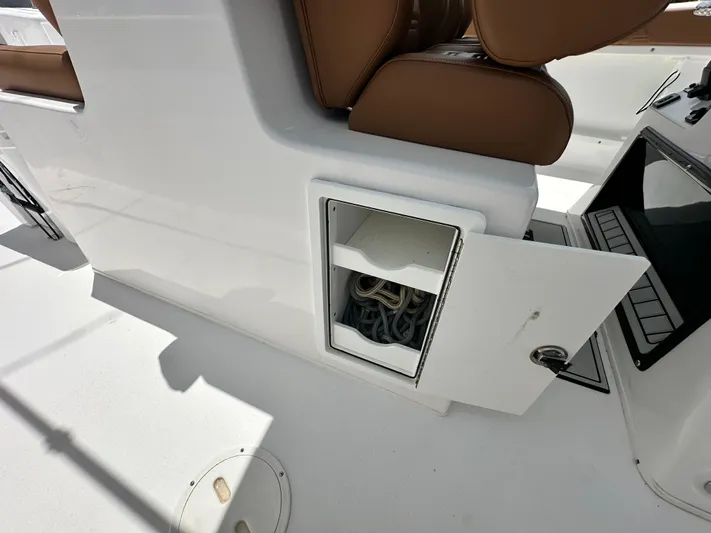  Yacht Photos Pics 2023 Twin Vee 340 GFX CC boat storage compartment with open door and visible ropes.