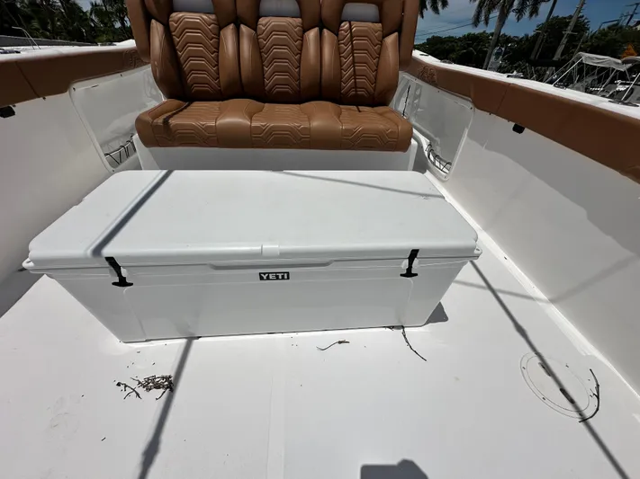  Yacht Photos Pics 2023 Twin Vee 340 GFX CC boat interior with brown seating and Yeti cooler.