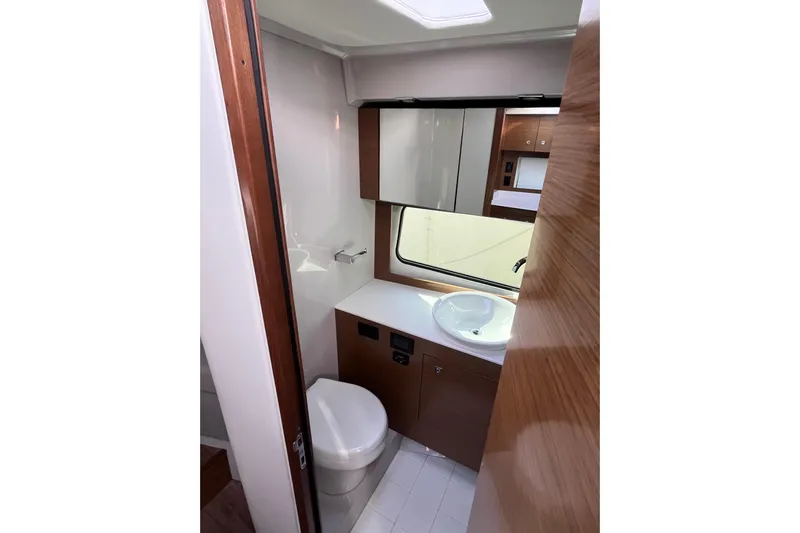  Yacht Photos Pics 2018 Cruisers Yachts 390 Express Coupe bathroom with modern fixtures and wood accents.