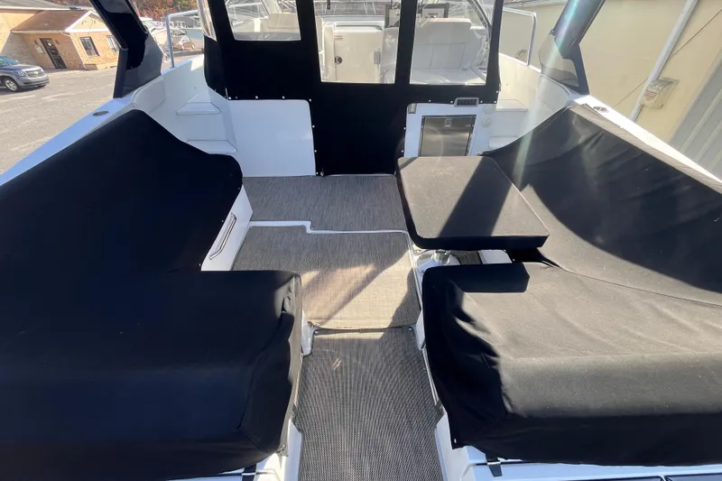  Yacht Photos Pics 2018 Cruisers Yachts 390 Express Coupe interior with black seating covers and carpeted floor.