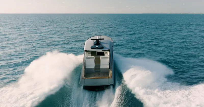  Yacht Photos Pics 2025 Buddy Davis 52 Express yacht cruising on open ocean waters.