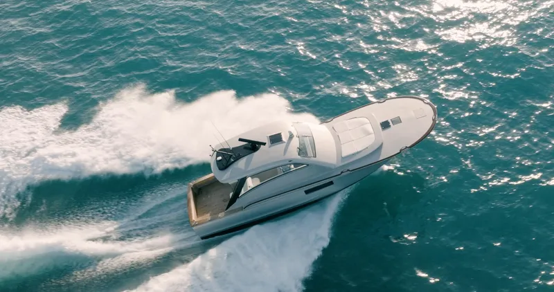  Yacht Photos Pics 2025 Buddy Davis 52 Express yacht cruising on open ocean waters.