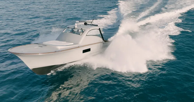  Yacht Photos Pics 2025 Buddy Davis 52 Express yacht cruising swiftly on open water.