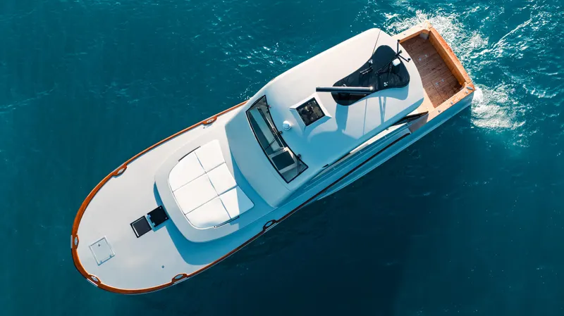  Yacht Photos Pics Aerial view of 2025 Buddy Davis 52 Express yacht cruising in blue ocean waters.