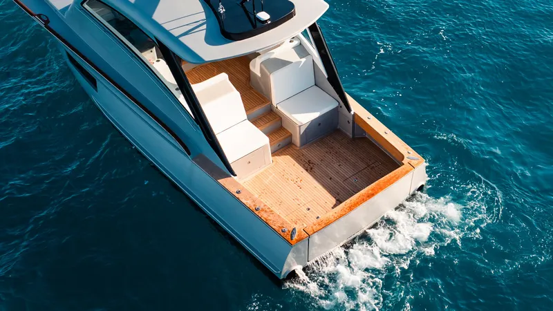  Yacht Photos Pics 2025 Buddy Davis 52 Express yacht cruising on blue ocean waters.