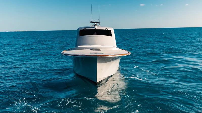  Yacht Photos Pics 2025 Buddy Davis 52 Express yacht cruising on open ocean waters.