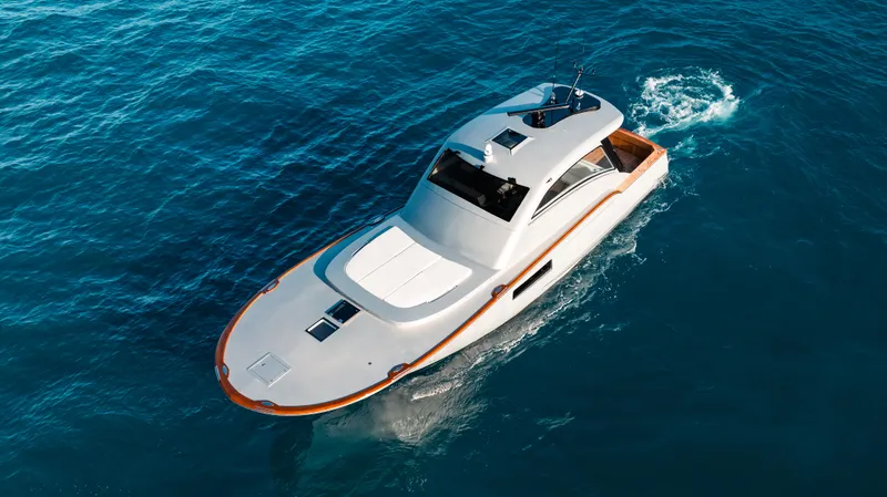  Yacht Photos Pics 2025 Buddy Davis 52 Express yacht cruising on clear blue water.