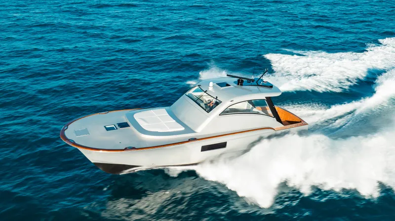  Yacht Photos Pics 2025 Buddy Davis 52 Express yacht cruising on open ocean waters.