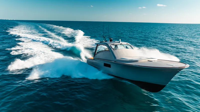  Yacht Photos Pics 2025 Buddy Davis 52 Express yacht cruising on open ocean waters.