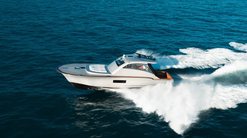  Yacht Photos Pics 2025 Buddy Davis 52 Express yacht cruising swiftly on open ocean waters.