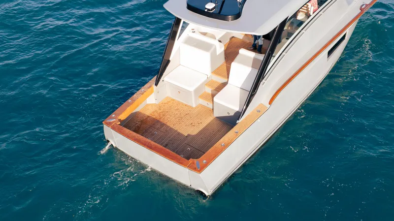  Yacht Photos Pics 2025 Buddy Davis 52 Express yacht on blue ocean water, showcasing sleek design and spacious deck.