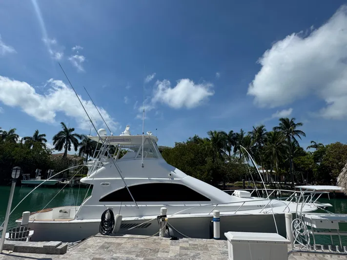  Yacht Photos Pics 2005 Ocean Yachts 50 Super Sport docked by palm trees under a clear blue sky.