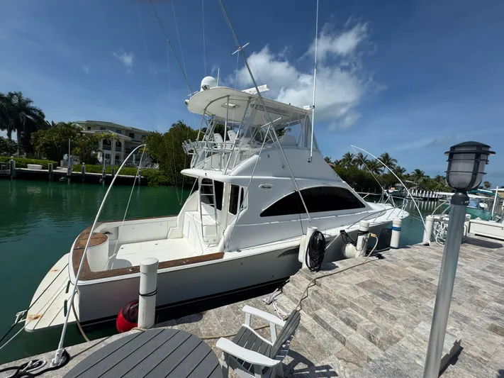  Yacht Photos Pics 2005 Ocean Yachts 50 Super Sport docked by a scenic waterfront.