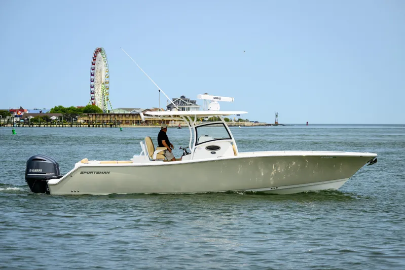  Yacht Photos Pics 2018 Sportsman Open 312 Center Console boat cruising near a Ferris wheel on calm waters.
