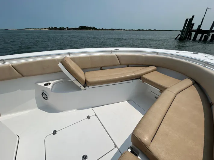  Yacht Photos Pics 2018 Sportsman Open 312 Center Console boat with tan seating, on calm water.