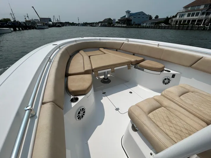  Yacht Photos Pics 2018 Sportsman Open 312 Center Console boat with beige seating, docked in a marina.