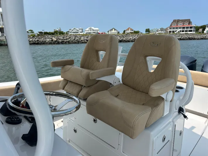  Yacht Photos Pics 2018 Sportsman Open 312 Center Console boat with tan captain seats, steering wheel, and waterfront view.