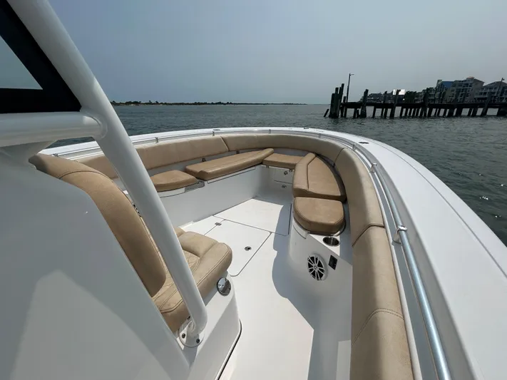  Yacht Photos Pics 2018 Sportsman Open 312 Center Console boat with spacious seating, docked near waterfront homes.