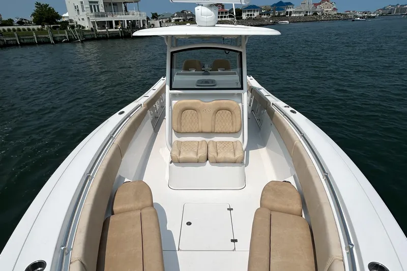  Yacht Photos Pics 2018 Sportsman Open 312 Center Console boat on water, featuring spacious seating and sleek design.