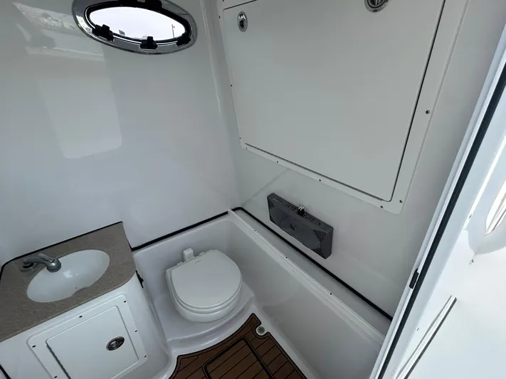  Yacht Photos Pics 2018 Sportsman Open 312 Center Console boat bathroom with sink and toilet.