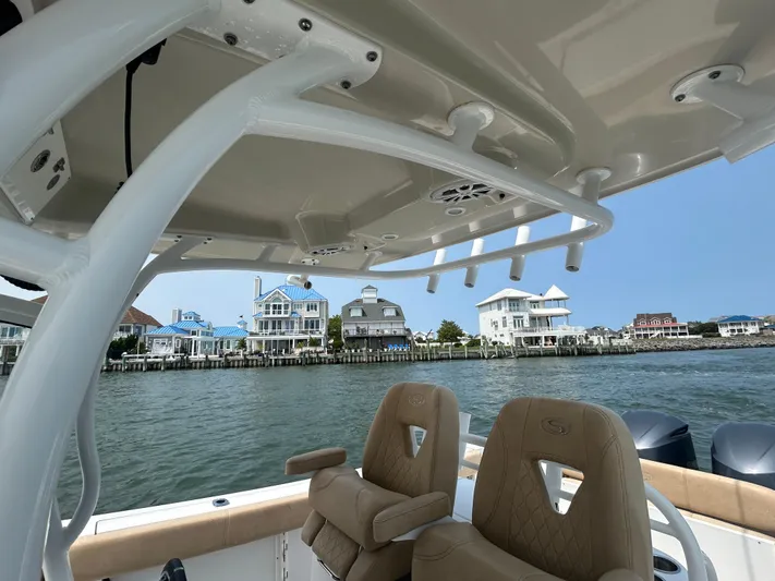  Yacht Photos Pics 2018 Sportsman Open 312 Center Console boat with waterfront homes in the background.