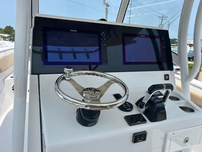  Yacht Photos Pics 2018 Sportsman Open 312 Center Console dashboard with dual screens and steering wheel.