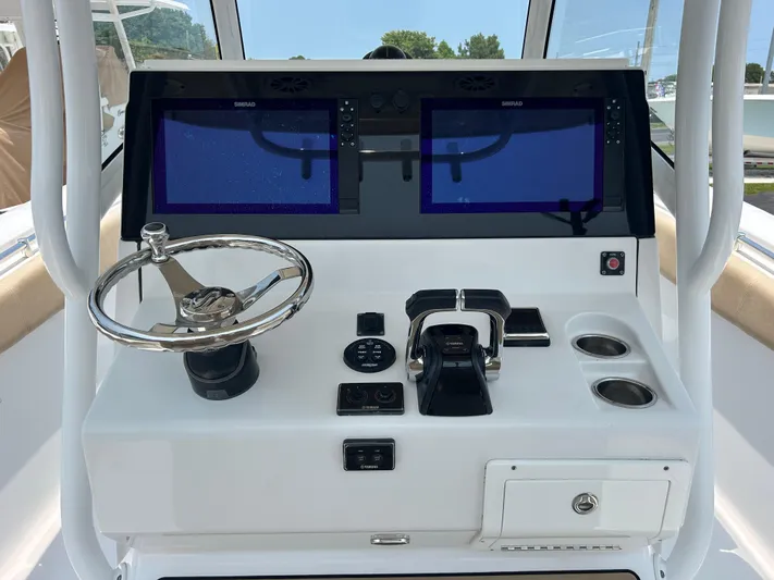  Yacht Photos Pics 2018 Sportsman Open 312 Center Console dashboard with dual screens and steering wheel.
