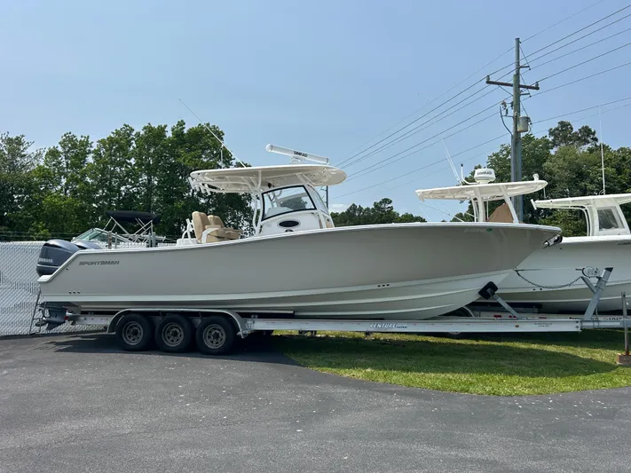  Yacht Photos Pics 2018 Sportsman Open 312 Center Console boat on a trailer, parked outdoors.