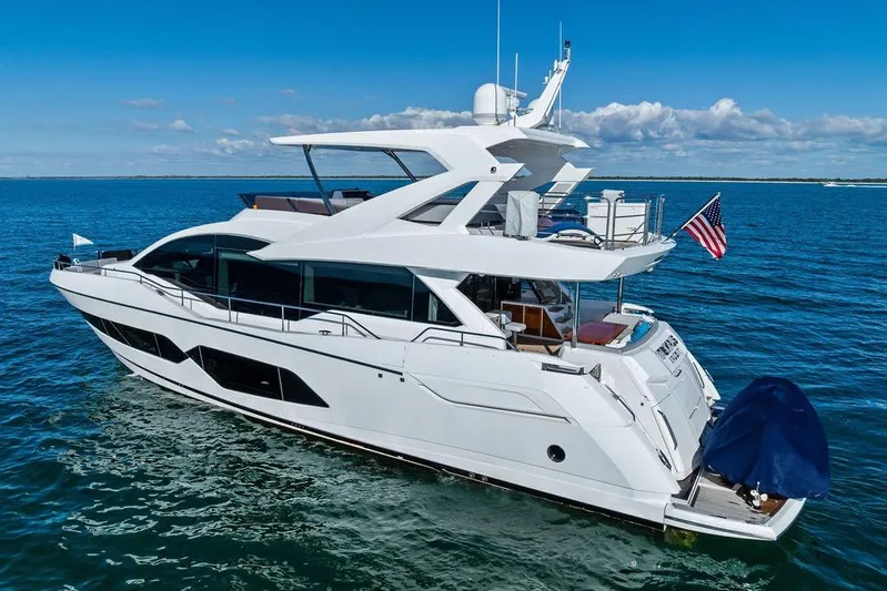 Tempus Fugit Yacht Photos Pics 2019 Sunseeker 76 Yacht cruising on open water under clear blue skies.