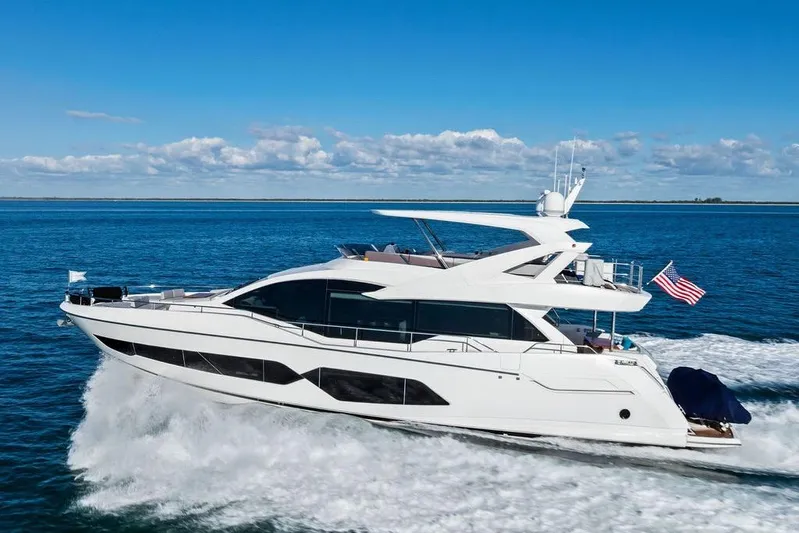 Tempus Fugit Yacht Photos Pics 2019 Sunseeker 76 Yacht cruising on open water under a clear blue sky.